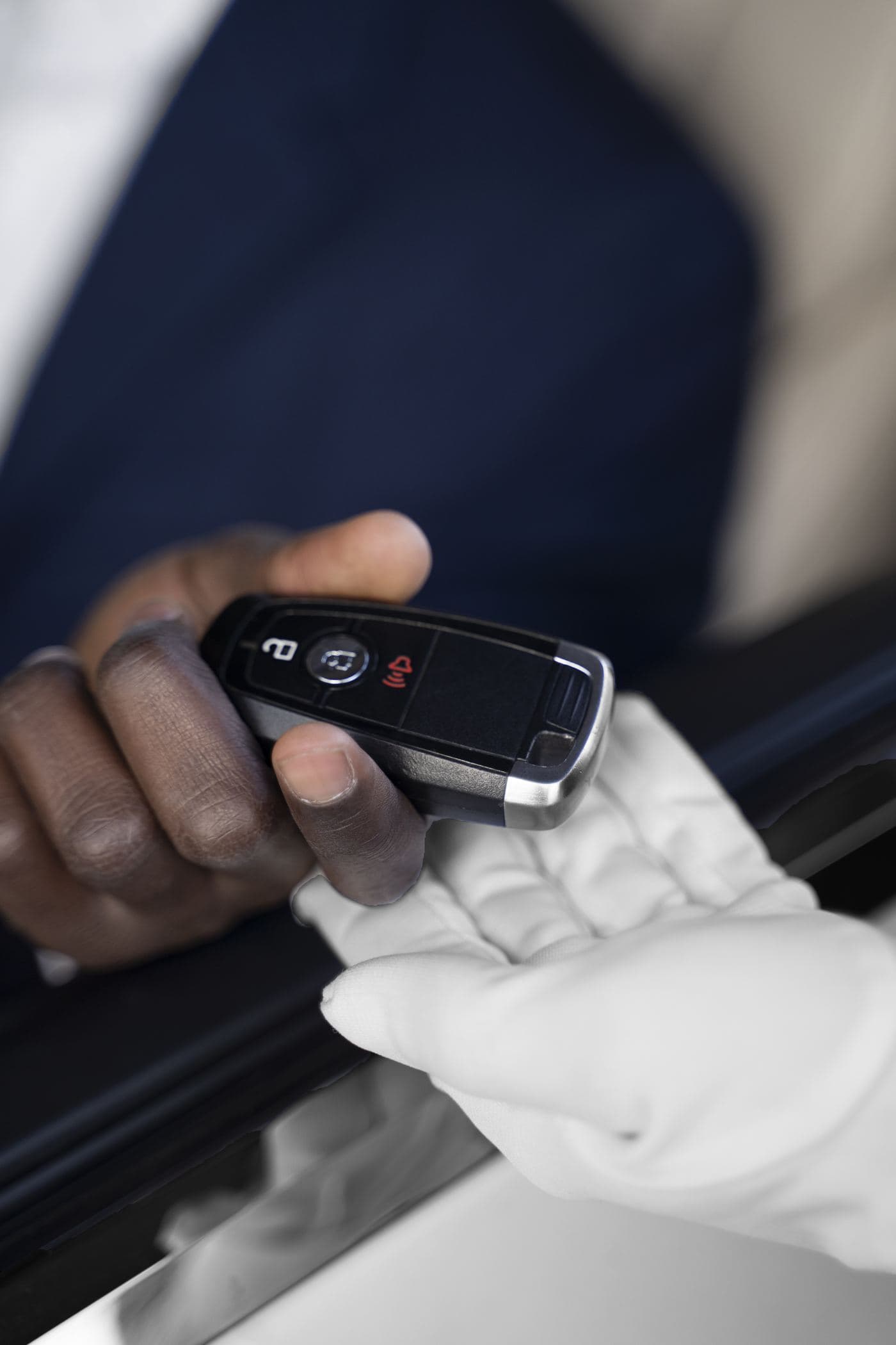 Chauffeur handing vehicle keys to a client