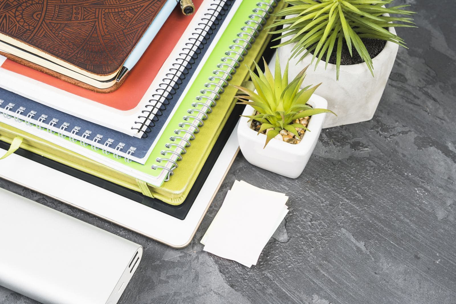 Stacked notebooks and stationery