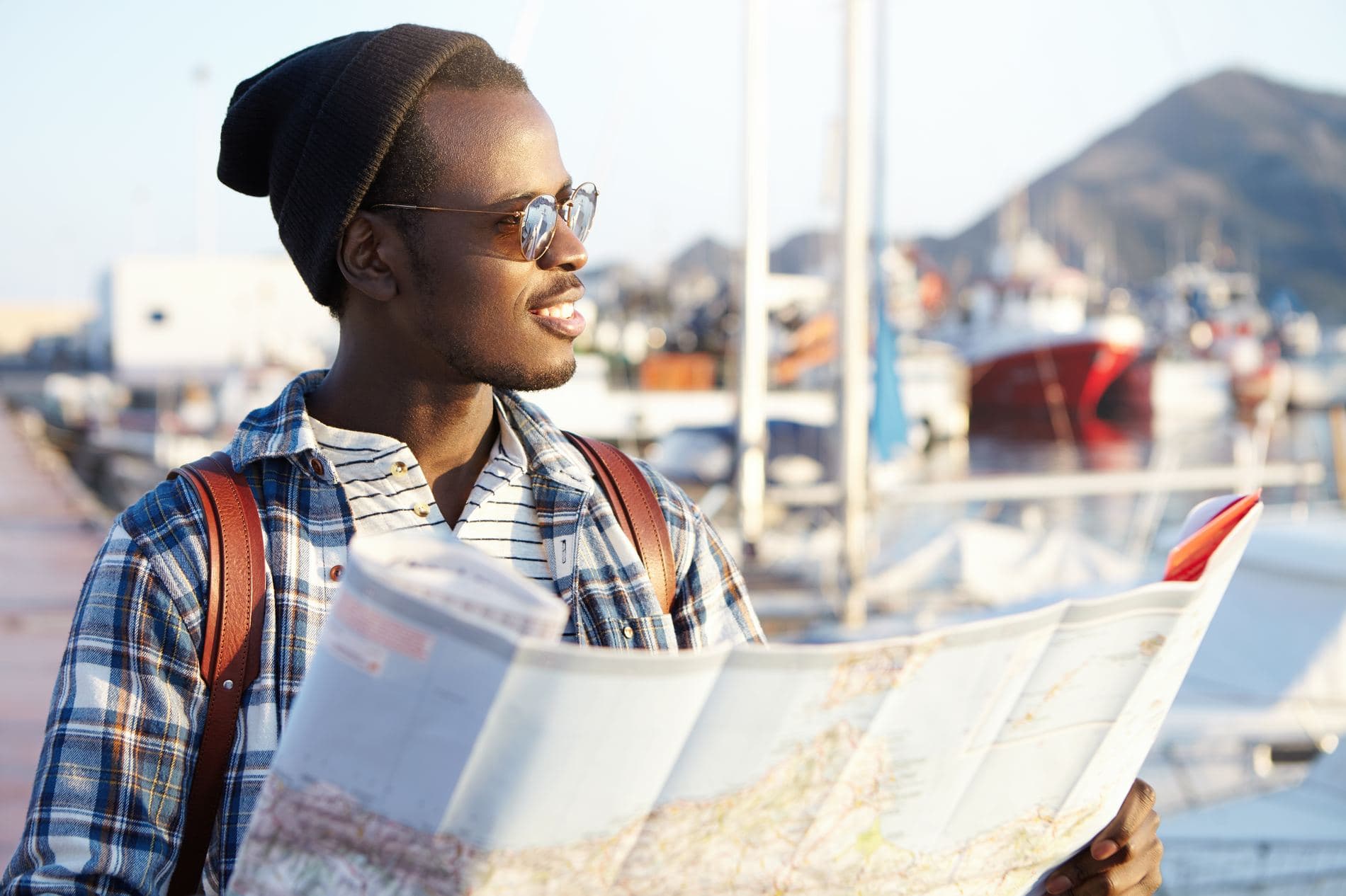 Traveller reading a map at a harbour